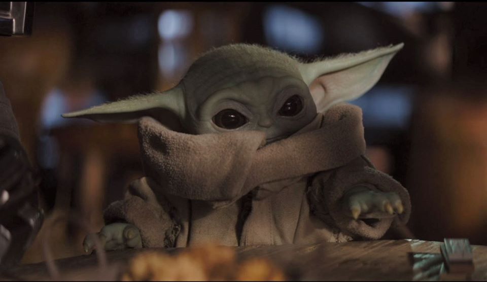 The meme is a screenshot of the character Baby Yoda from the Star Wars series, with a shocked expression on his face. The image is captioned "When you finally get to the last donut in the box".